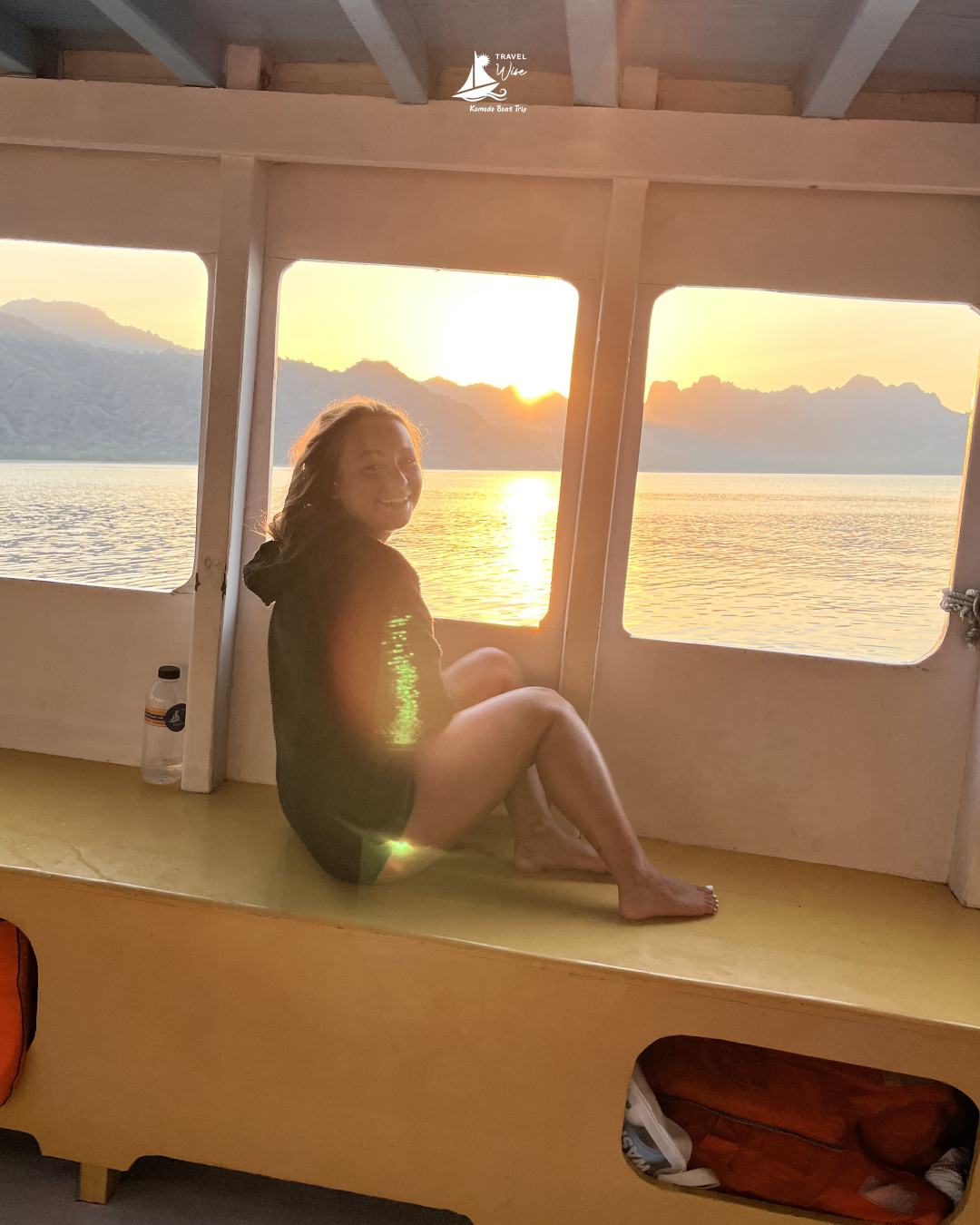 Travelers relaxing on the boat deck while the sun sets over the sea